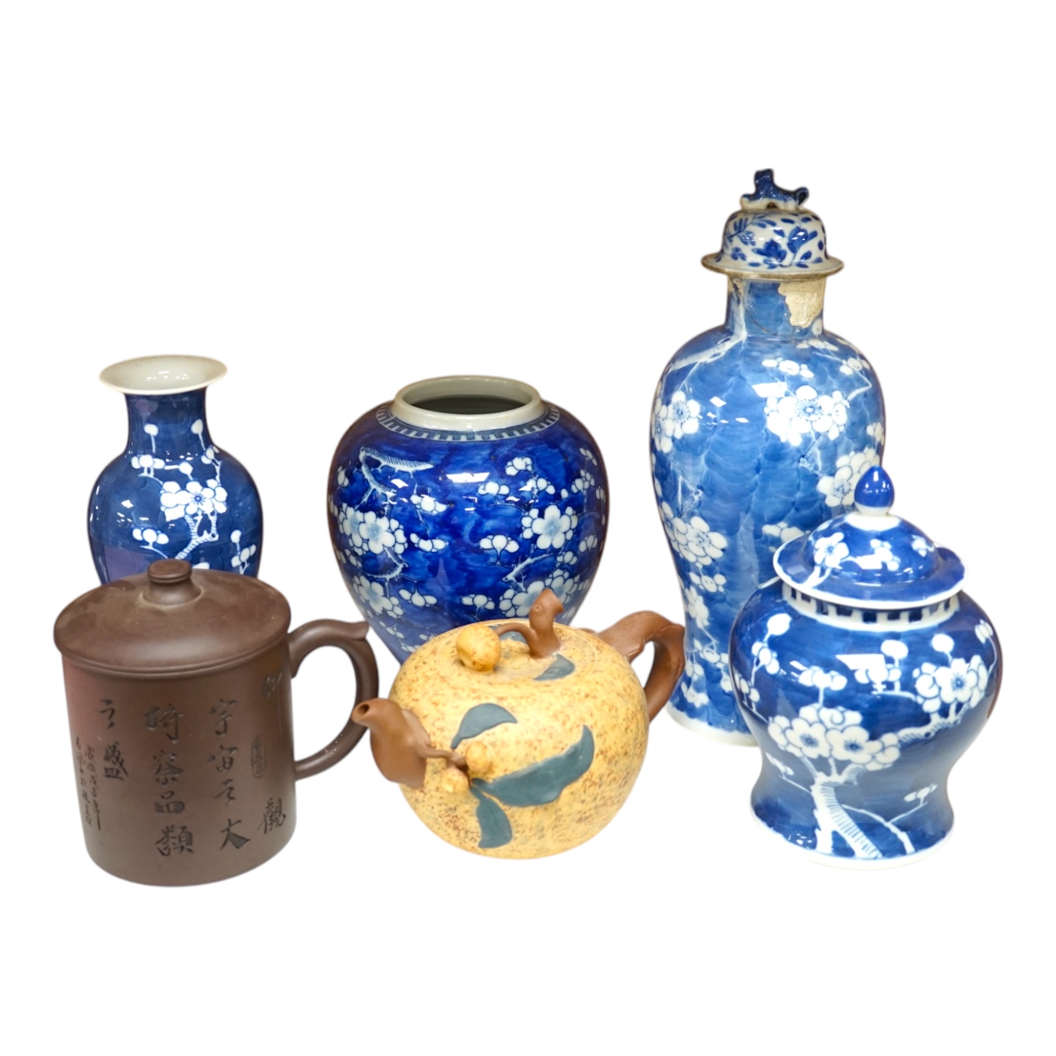 Two Chinese prunus jars and two vases, early 20th century, tallest 26cm, together with two Chinese Yixing pottery teapots, one Republic period, tallest 12.5cm. Condition - varies, poor to fair